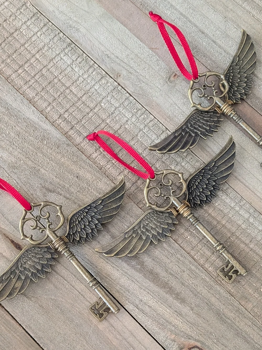Vintage Brass Winged Key Ornament with Red Ribbon